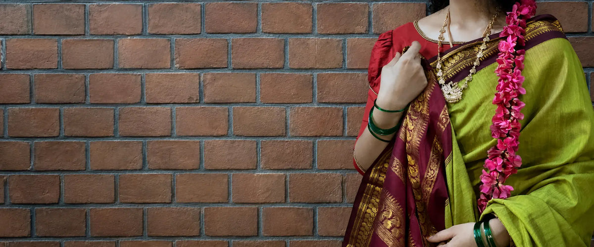 Woman wearing a lime green saree with maroon and gold border — Ammavin Alamari